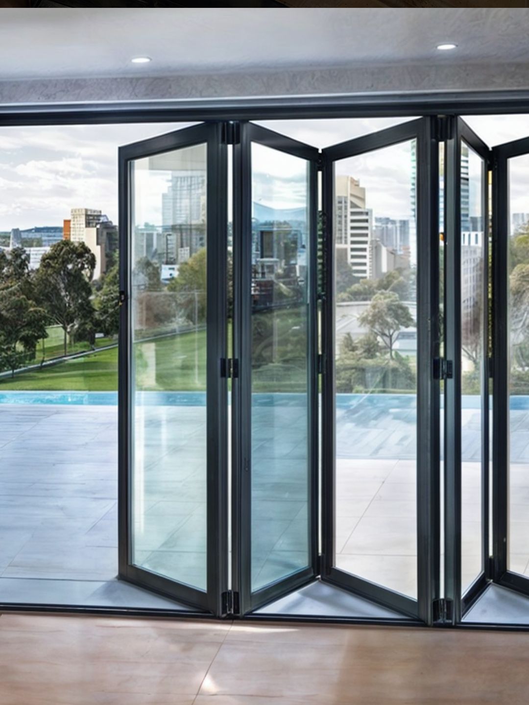 Aluminium bi-fold glass doors opening to a terrace